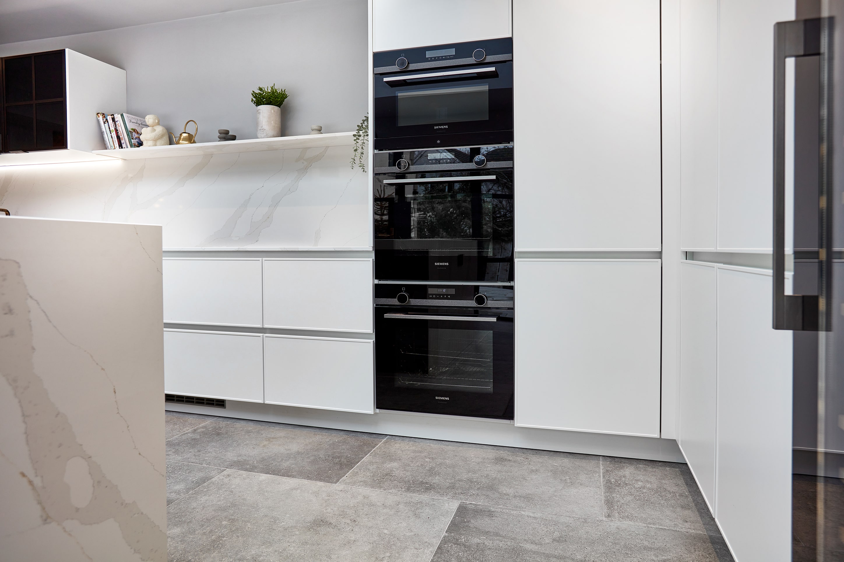 Siemens iQ500 integrated oven and combination microwave tower in handleless white kitchen, Leeds
