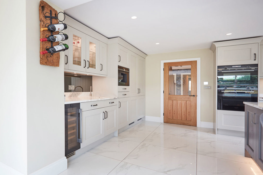 Grey and cream shaker kitchen with wine cooler