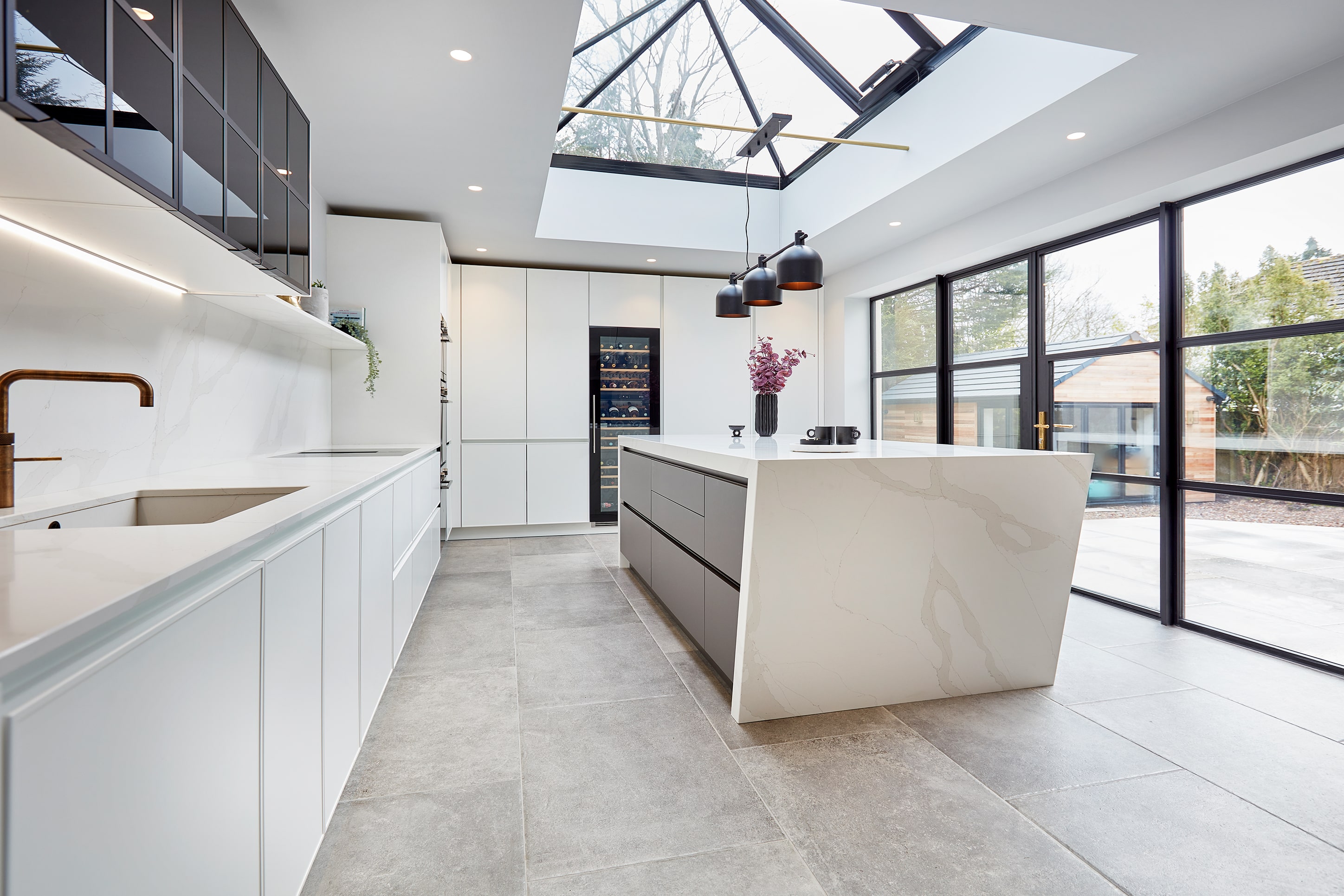 Handleless kitchen island with angled quartz waterfall end, Adel Leeds